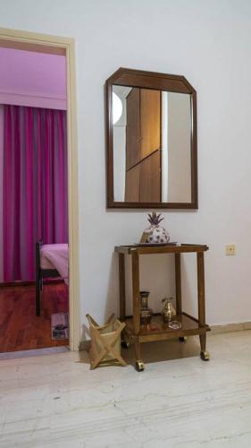 a room with a mirror and a wooden table at Athena's apartment in Kardítsa