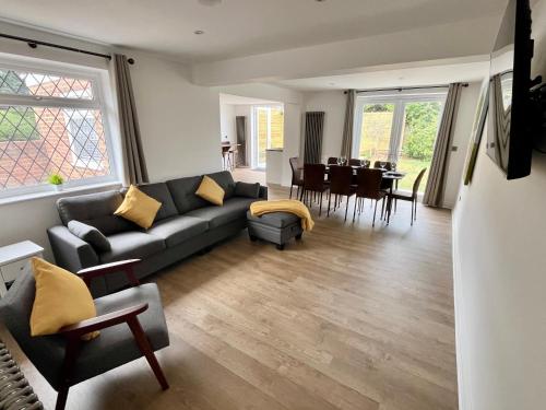 a living room with a couch and a dining room at Olive Tree Brighton-Bright & Spacious 4 bedroom home with Garden & Free parking in Brighton & Hove