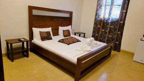 a bedroom with a bed with white sheets and pillows at Treasures of Zanzibar House in Zanzibar City