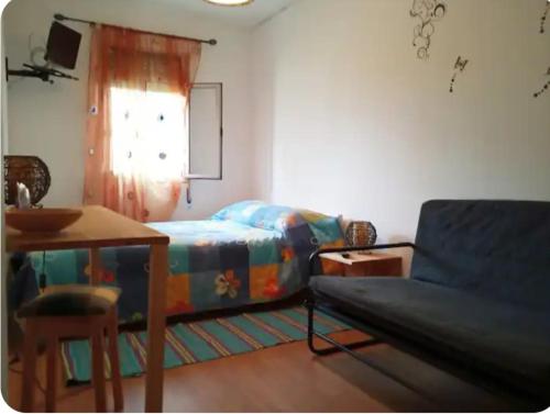 a living room with a couch and a table at Casa do Ruben Lisboa in Lisbon