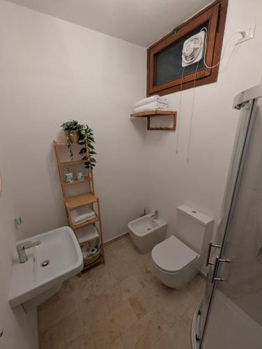 a bathroom with a toilet and a sink and a shower at Casa Mia in Tremezzo