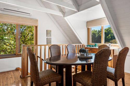 a dining room with a table and chairs at Berry Beach Holiday Cottage in Berry