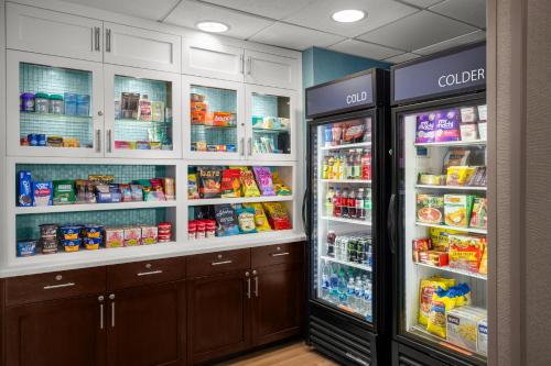 a store refrigerator with its doors open and food inside at Homewood Suites by Hilton Dulles-North Loudoun in Ashburn