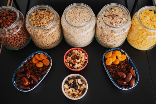 a group of glass jars filled with different types of nuts at Hotel Matija Gubec in Stubicke Toplice