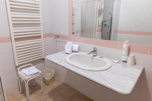 a bathroom with a sink and a mirror at Toscana Wellness Resort in Arcidosso