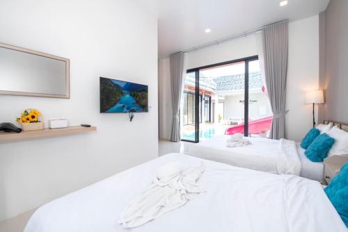 En eller flere senge i et værelse på Miguel Pool Villa