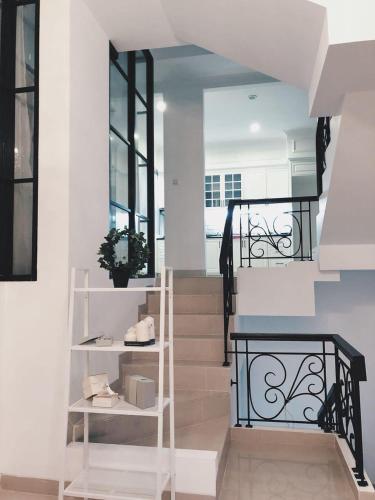 a stairway with a white staircase with a stair case at White House Private Room at PIK in Jakarta
