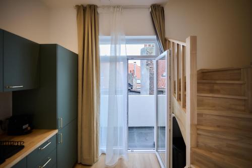 a kitchen with a sliding glass door to a window at Apartment Berthelot 5 in Brussels
