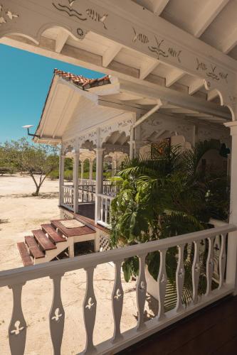 a white porch with a gazebo on the beach at Hotel Agua Azul Beach Resort in Baru