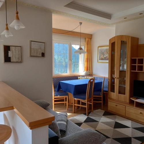 a living room with a blue table and chairs at Residence Wiesenheim in Trodena