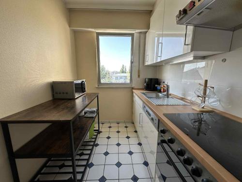 a small kitchen with a counter and a window at Rooftop 1 bed sleeps 4 in Luxembourg