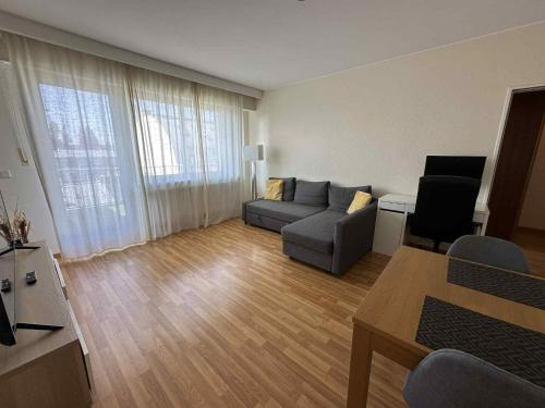 a living room with a couch and a table at Rooftop 1 bed sleeps 4 in Luxembourg