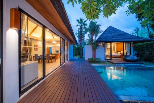 an external view of a villa with a swimming pool at BangTao Anchan 豪华两卧 私人泳池 现代度假巴厘风 in Layan Beach