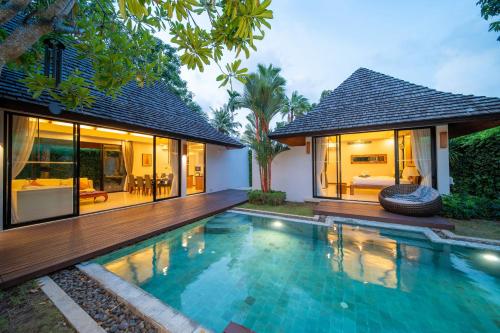 a swimming pool in front of a villa at BangTao Anchan 豪华两卧 私人泳池 现代度假巴厘风 in Layan Beach