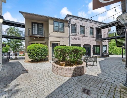 a brick courtyard with a building and a bench at Carters Court Grand Escape in Franklin