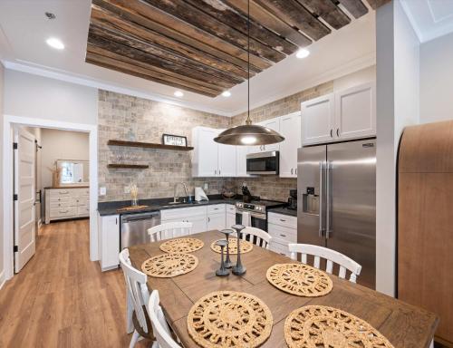 a kitchen with a wooden table and a refrigerator at Carters Court Grand Escape in Franklin