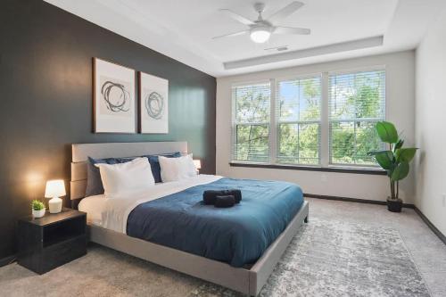 a bedroom with a large bed with a blue blanket at Luxe King 3 Bedroom Suite in North Raleigh in Wake Forest
