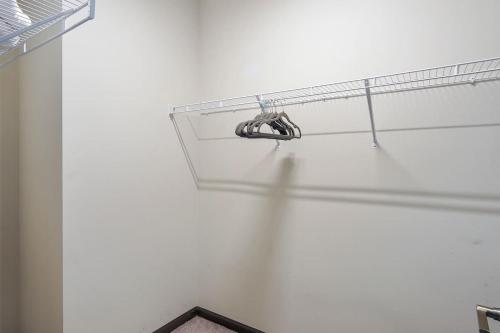 a white room with a shelf with a shoe at Luxe King 3 Bedroom Suite in North Raleigh in Wake Forest