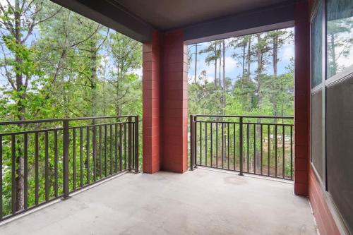 an empty balcony with a view of trees at Luxe King 3 Bedroom Suite in North Raleigh in Wake Forest