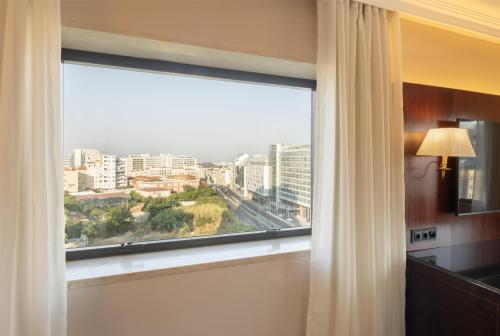 a window in a room with a view of a city at Dom Pedro Lisboa Hotel, a member of Radisson Individuals in Lisbon