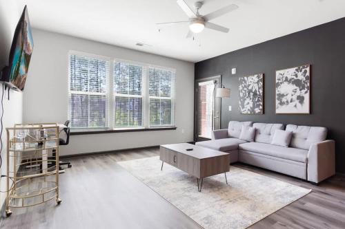 a living room with a couch and a table at Luxe King 2 Bedroom Suite in North Raleigh in Wake Forest