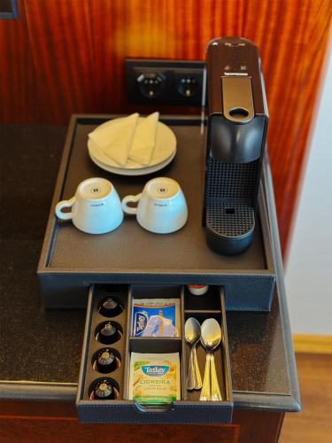 a table with a tray with a phone and utensils at Dom Pedro Lisboa Hotel, a member of Radisson Individuals in Lisbon