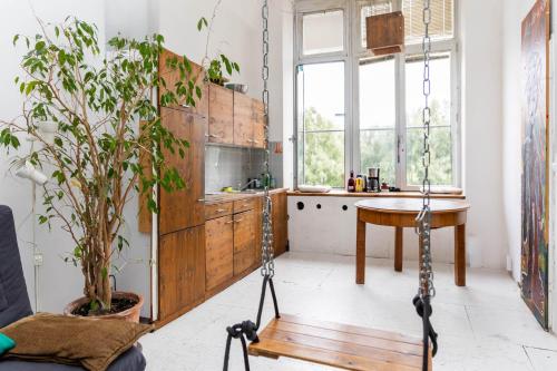 a kitchen with a swing in the middle of a room at Einzigartiges 140qm LOFT – Party ist erlaubt! in Berlin