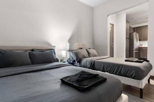 a bedroom with two beds and a kitchen at Luxe King 3BR Suite North Raleigh in Wake Forest