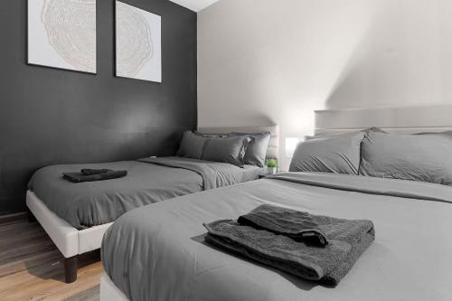 a bedroom with two beds with towels on them at Luxe King 3BR Suite North Raleigh in Wake Forest