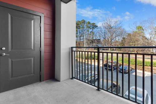 a door to a balcony with a view of a car at Luxe King 3BR Suite North Raleigh in Wake Forest