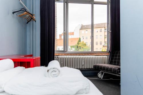 a bedroom with a bed and a large window at Einzigartiges 140qm LOFT – Party ist erlaubt! in Berlin