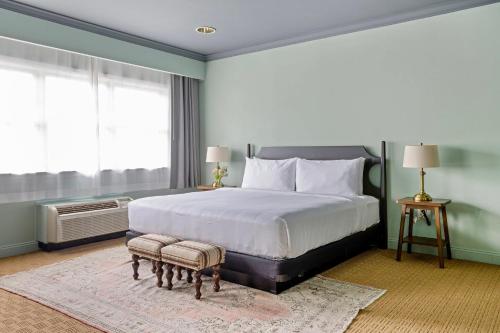 a bedroom with a large bed and a large window at The Harbor Front Inn in Greenport