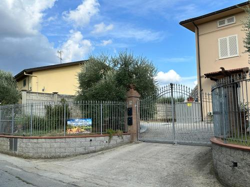 a wrought iron gate in front of a house at Casa in mezzo agli Ulivi in Lamporecchio