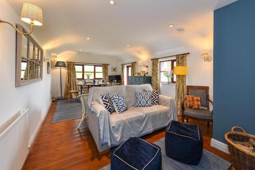 a living room with a couch and a chair at Trefaes Bach in Abersoch