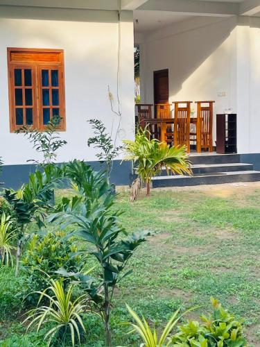a house with some plants in front of it at Nachchi Sweet Beach Stay in Nilaveli