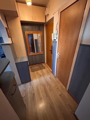 an empty hallway with a door and a refrigerator at Bliss Home in Gheorgheni