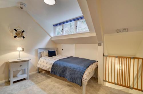 a bedroom with a bed and a window at Fox Cottage in Lynmouth