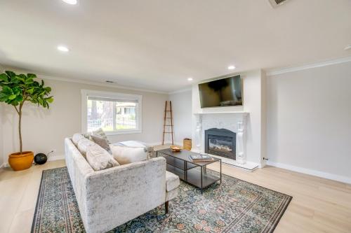 a living room with a couch and a fireplace at Waterfront Gem with Boat Dock and Lift in Lakewood! in Lakewood