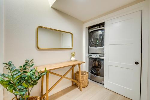 a laundry room with a mirror and a washer and dryer at Waterfront Gem with Boat Dock and Lift in Lakewood! in Lakewood