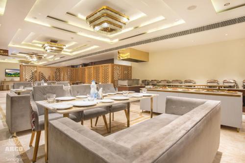a dining room with a table and chairs at ARCO Hotels and Resorts Srinagar in Srinagar