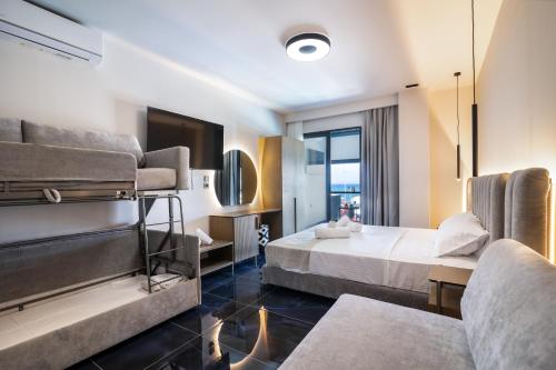 a hotel room with two beds and a couch at Papagalakia Resort & Apartments in Aiándion