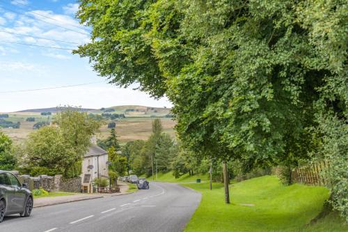 a street with cars parked on the side of a road at Mount Pleasant in Tebay