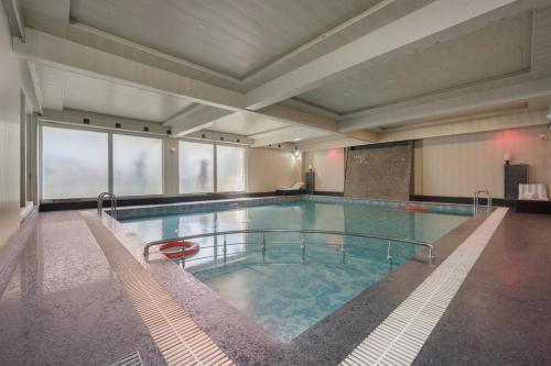 a large swimming pool in a large building at ARCO Hotels and Resorts Srinagar in Srinagar