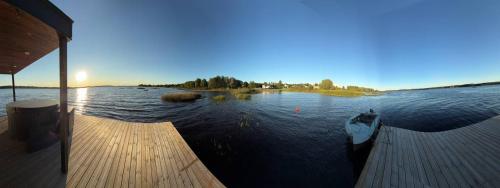 a boat on the water next to a dock at Laivu nomas pirts in Ikšķile