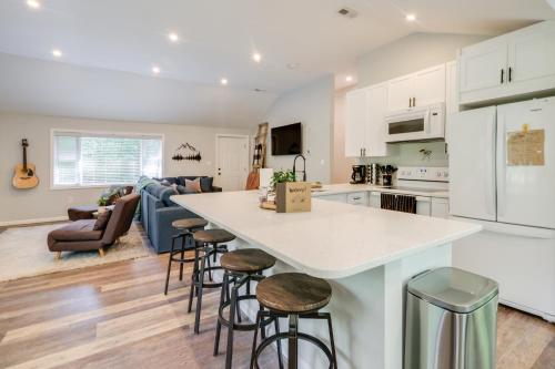 a kitchen and living room with a counter and stools at half Acre Pond, Rec Room! Private Oasis in Nanjemoy 