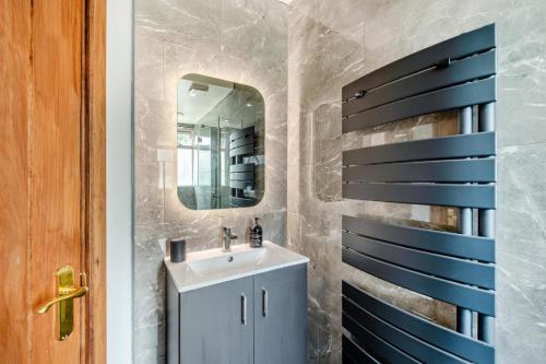 a bathroom with a sink and a mirror at The Old Butchers in Chilham