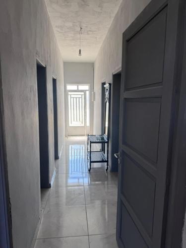an open door in a hallway with a chair at PANKO Suite in Dhímitra