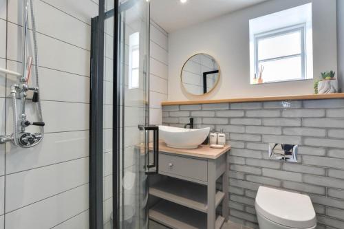 a bathroom with a sink and a shower at Mariners View in Padstow
