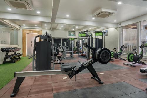 a gym with several treadmills and machines at ARCO Hotels and Resorts Srinagar in Srinagar