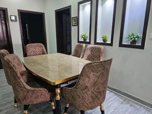 a conference room with a table and chairs at Majestic Family Lodges in Islamabad